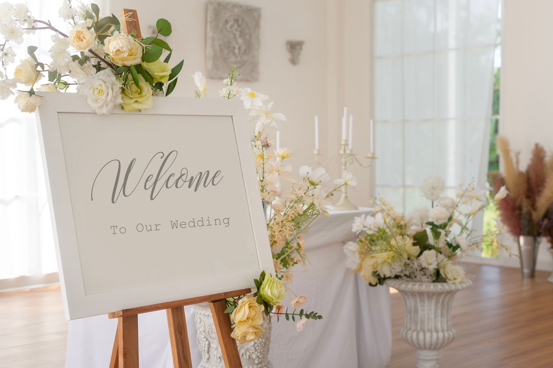 Welcome to wedding sign and reception table decorated with flowers